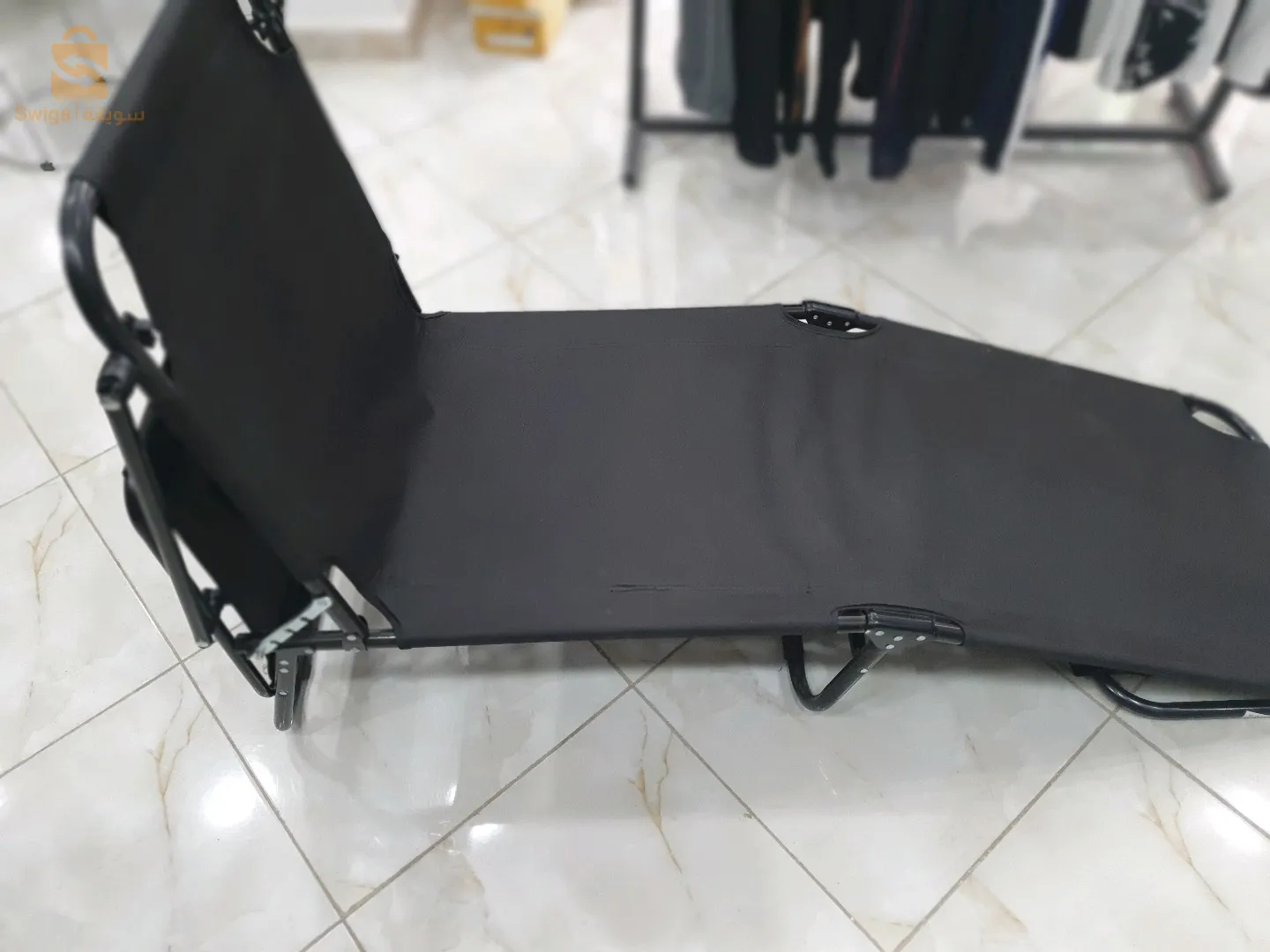 The beach chair is equipped with an umbrella