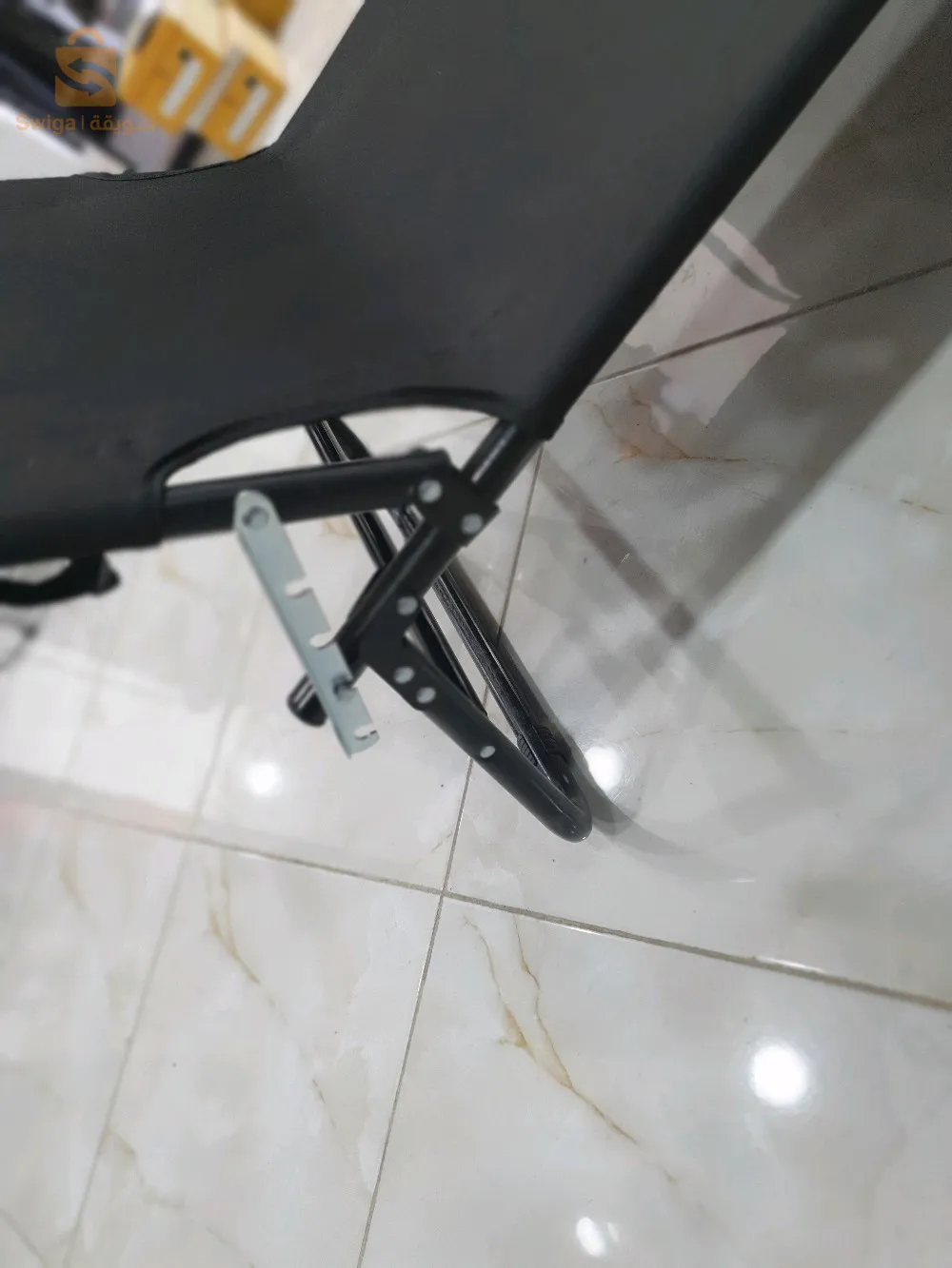 The beach chair is equipped with an umbrella