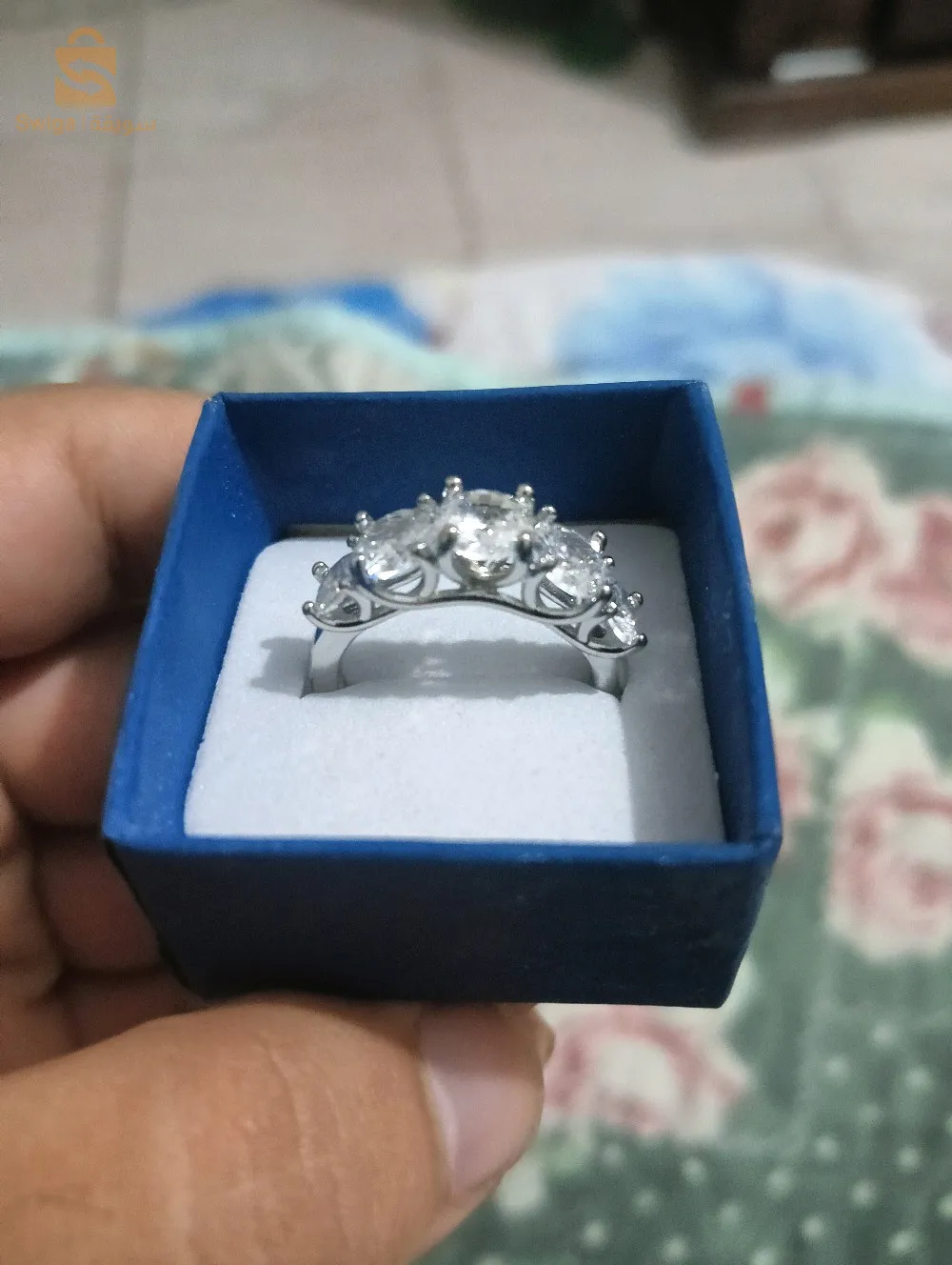 Silver ring overlaid with white gold, featuring five stones.