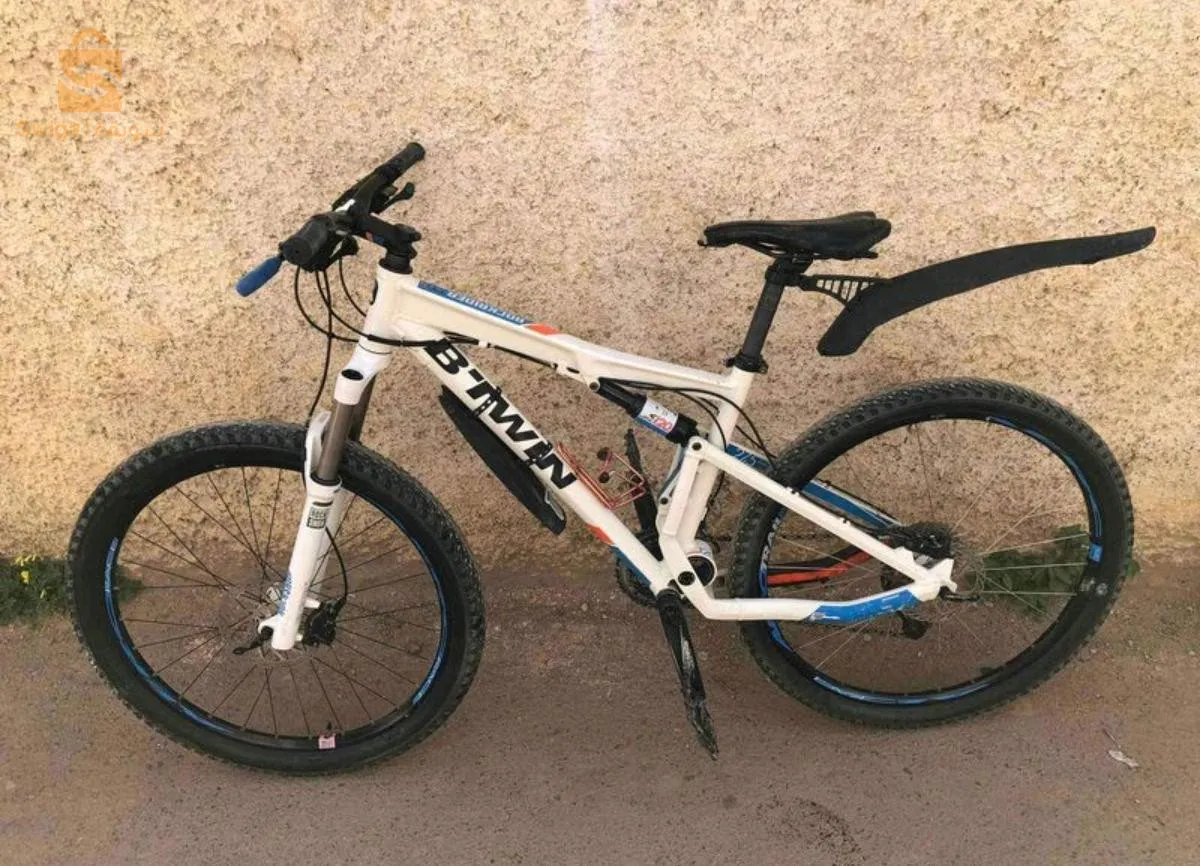 Velo rockrider bzaaf toop fran lokid duble amortiseur f rock chok haja tae jebal