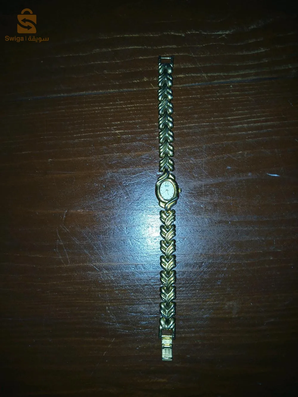 Montre vintage de la marque "Saicko" (probablement inspirée de la marque japonaise "Seiko"). Elle est dotée d'un bracelet en métal doré à motif en forme de feuilles, offrant un style élégant et classique. Le cadran est de petite taille, avec un affichage analogique, idéal pour ceux qui recherchent une montre raffinée au design rétro. Elle est en bon état et prête à être portée.