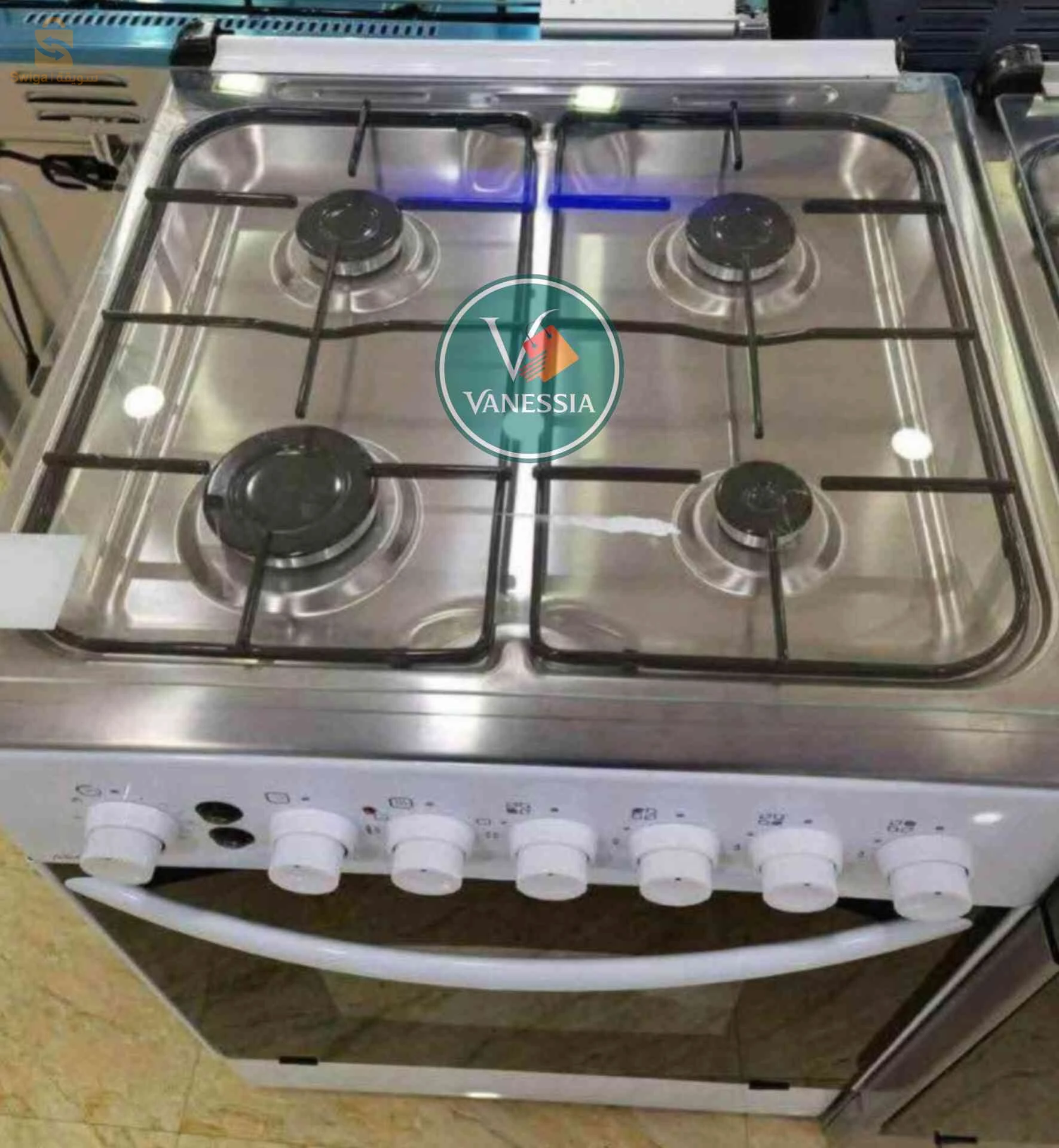 une cuisinière du marque arcodym simple avec trois couleurs (blanc, beige,marron)